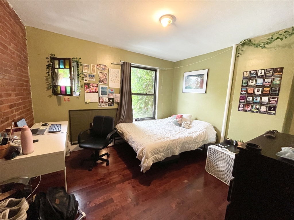 74 Hammond Street, Unit 2 Boston, MA 02120 - Photo 4 of 10 a bedroom with a bed and wooden floor