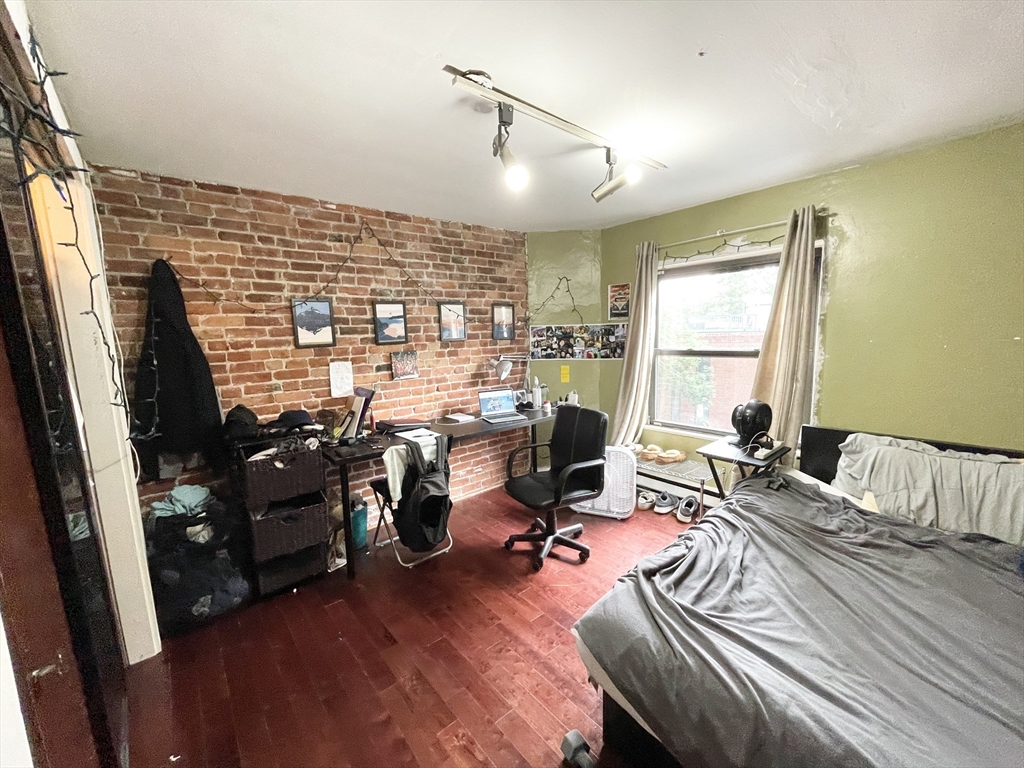74 Hammond Street, Unit 2 Boston, MA 02120 - Photo 7 of 10 a view of a livingroom with workspace and a window