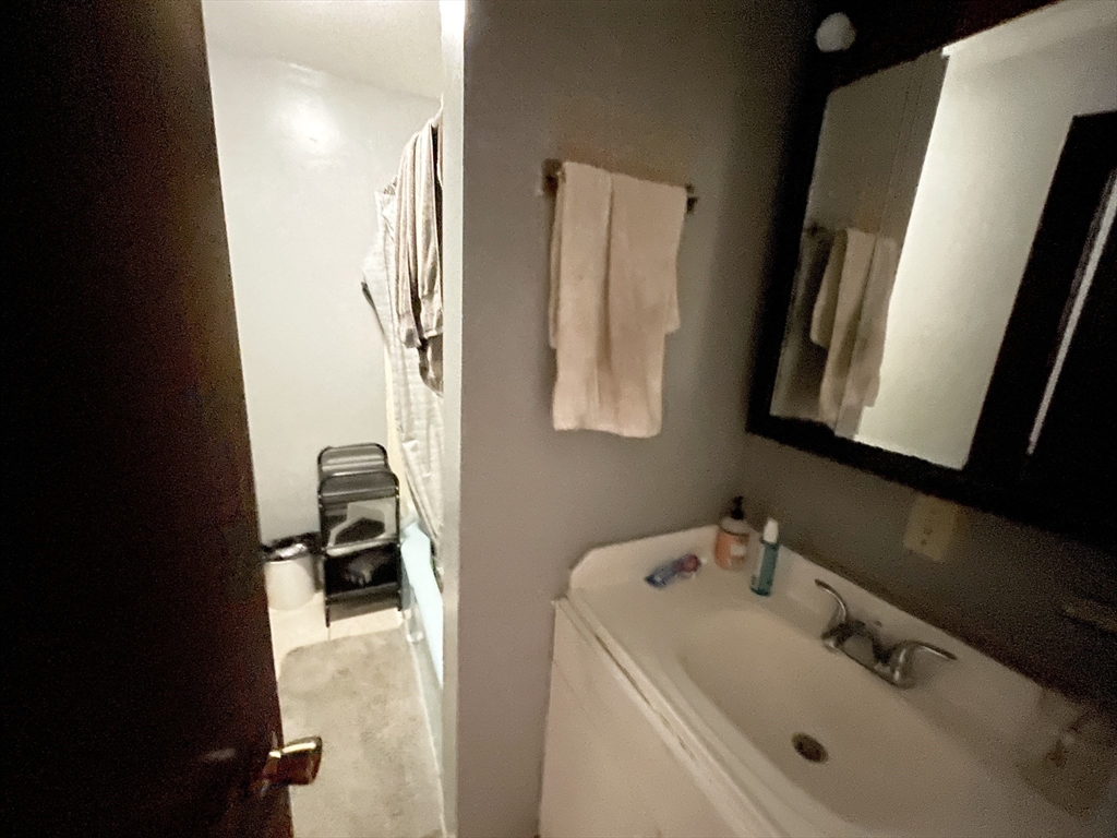 74 Hammond Street, Unit 2 Boston, MA 02120 - Photo 8 of 10 a bathroom with a sink and a mirror