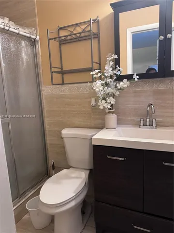 a bathroom with a sink toilet and mirror