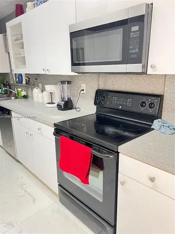 a stove top oven sitting inside of a kitchen