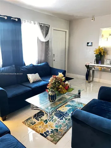 a living room with furniture and a table