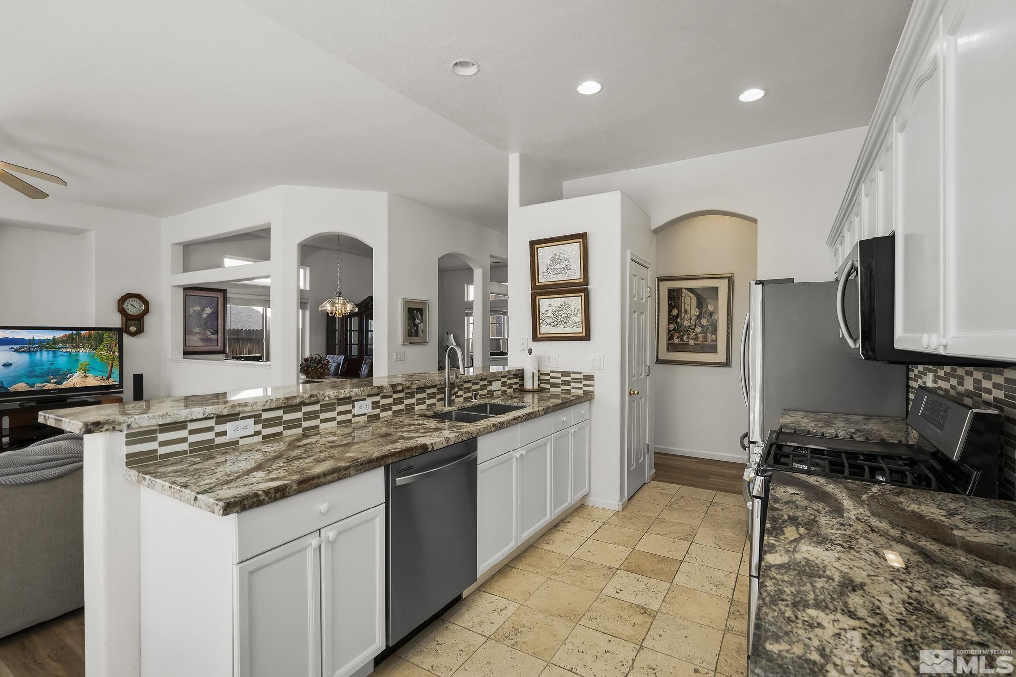 1732 Colavita Way Reno, NV 89521 - Photo 4 of 22 a kitchen with stainless steel appliances granite countertop a stove a sink and a refrigerator