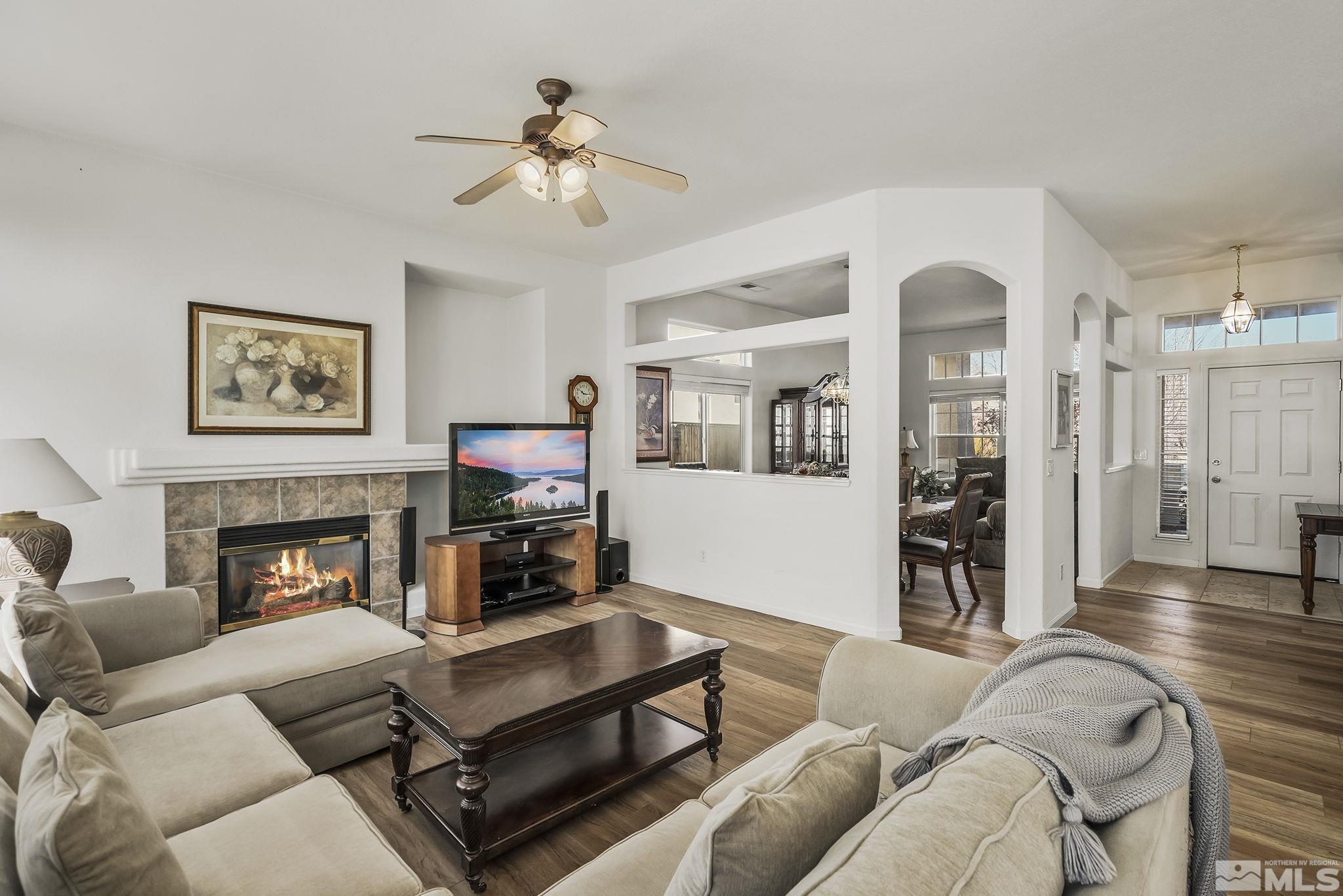 1732 Colavita Way Reno, NV 89521 - Photo 7 of 22 a living room with furniture fireplace and wooden floor