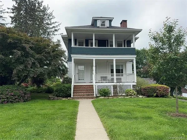 a front view of a building with a yard