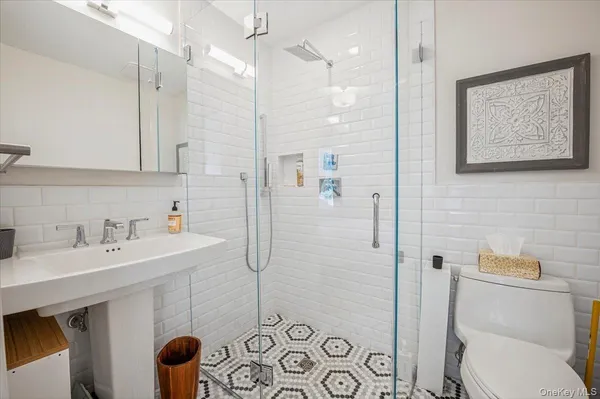 a bathroom with a sink toilet and shower