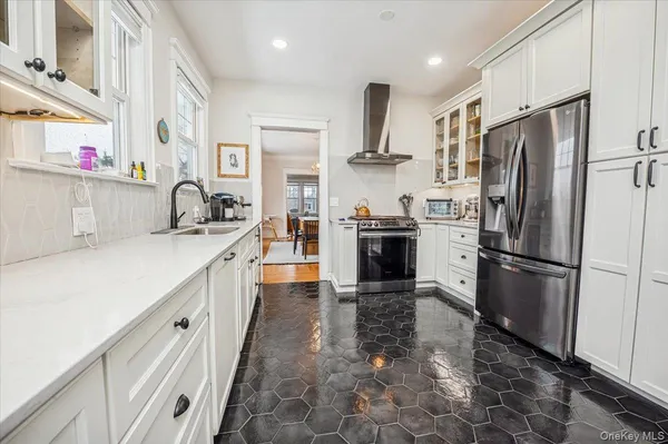 a kitchen with refrigerator a sink and cabinets
