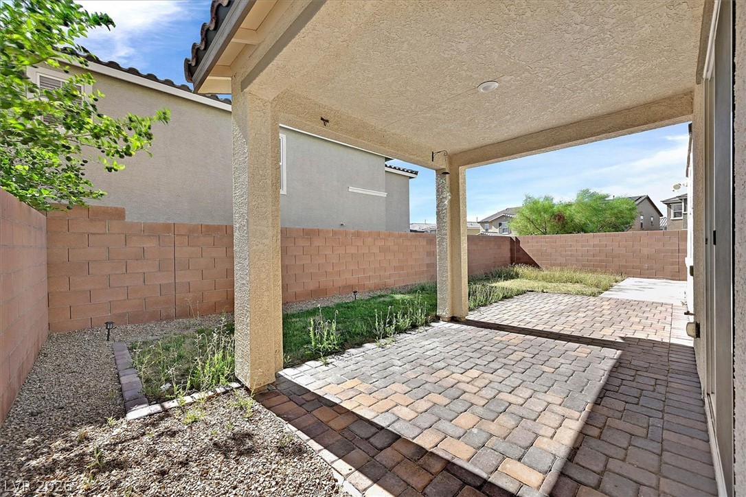 2823 Turnstone Ridge Street Henderson, NV 89044 - Photo 23 of 25 A covered patio offers an ideal outdoor living space, complementing the fenced yard.