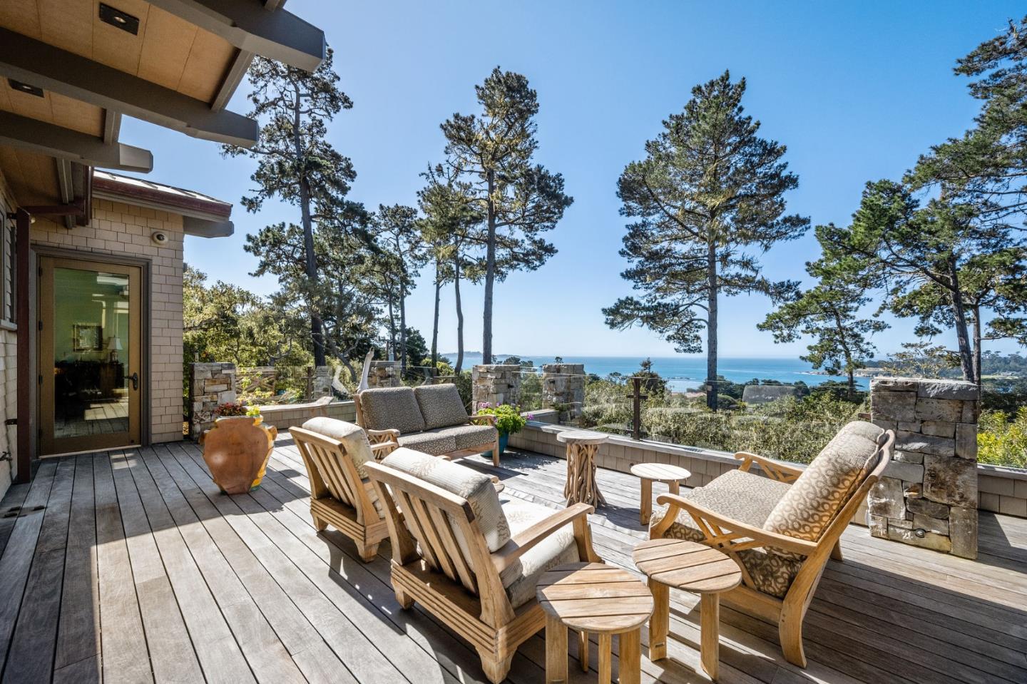 3204 Palmero Way Pebble Beach, CA 93953 - Photo 19 of 93 a view of a patio with dining table and chairs with wooden floor and fence