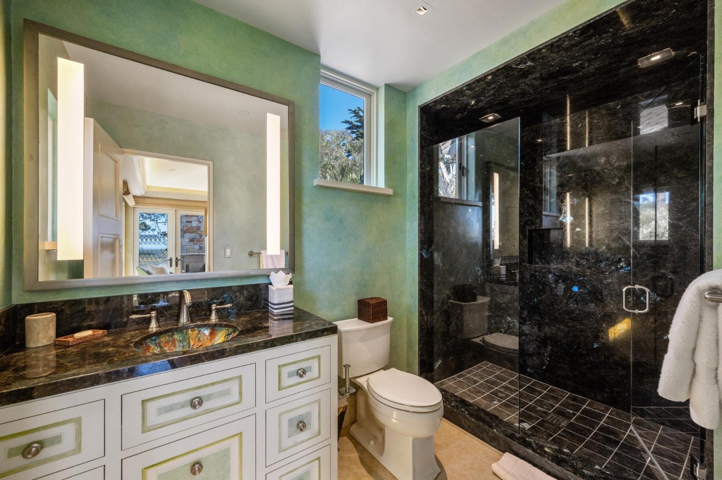3204 Palmero Way Pebble Beach, CA 93953 - Photo 72 of 93 a bathroom with a granite countertop sink a toilet a mirror and shower