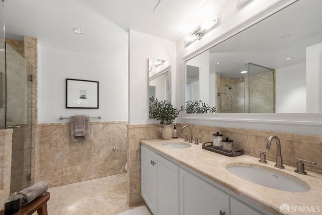 a bathroom with a granite countertop sink mirror and double