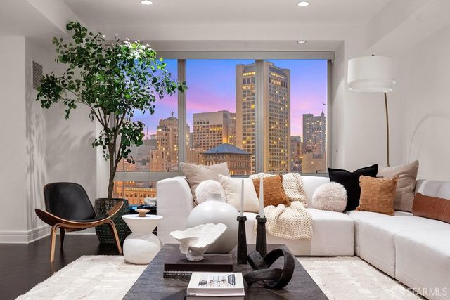 a living room with furniture and a potted plant
