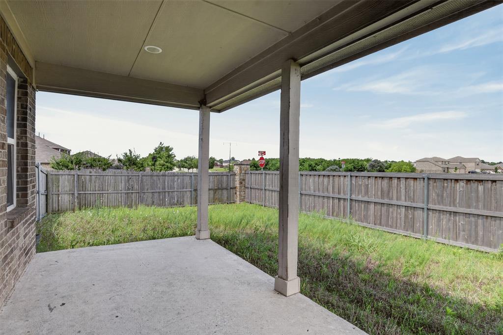 9105 Switchgrass Lane Forney, TX 75126 - Photo 19 of 20 Covered concrete patio with recessed lighting, brick exterior, and a wooden privacy fence