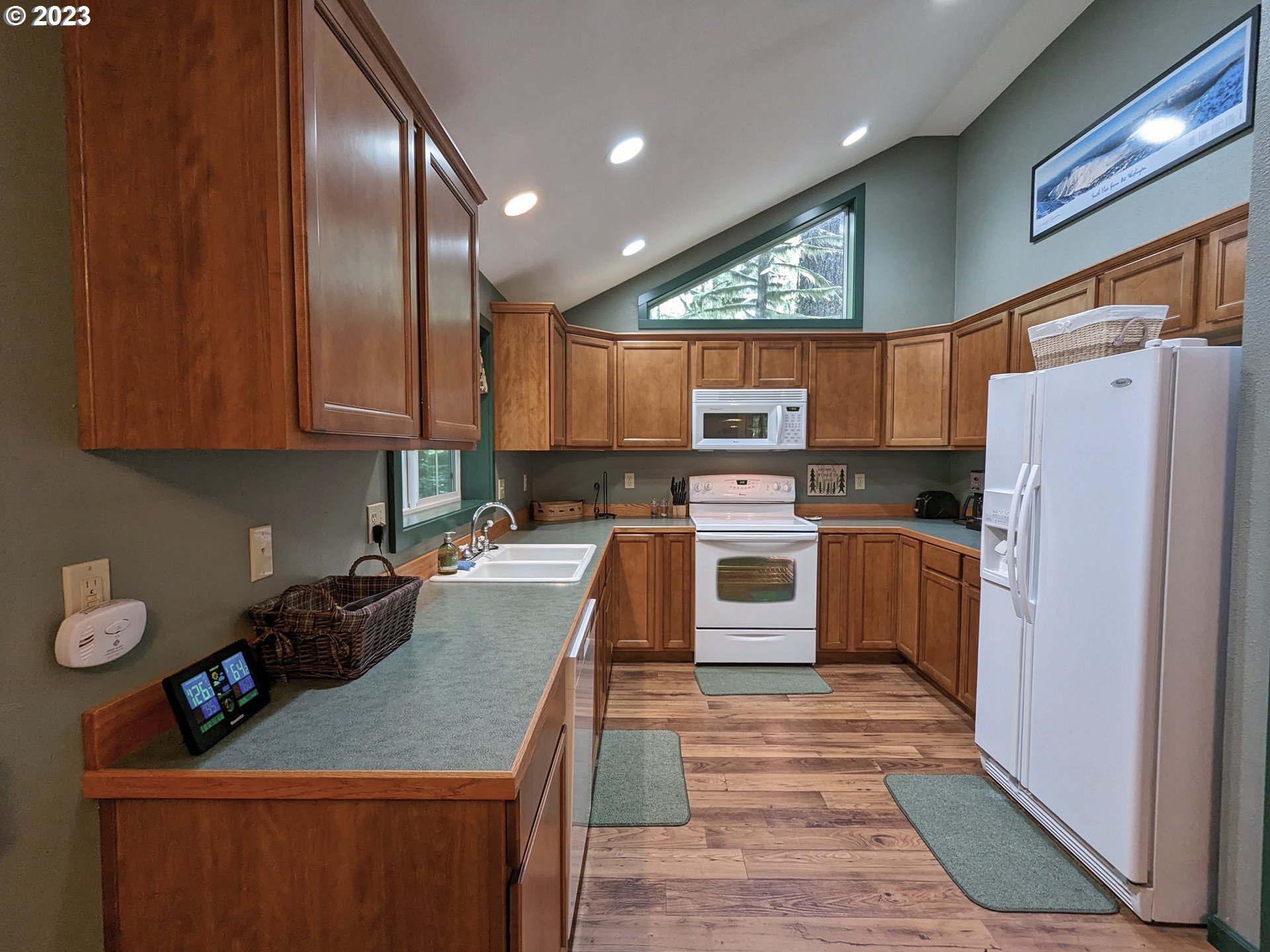 28084 Road 20 D Rhododendron, OR 97049 - Photo 15 of 32 a kitchen with granite countertop stainless steel appliances a refrigerator a stove top oven a sink and cabinets