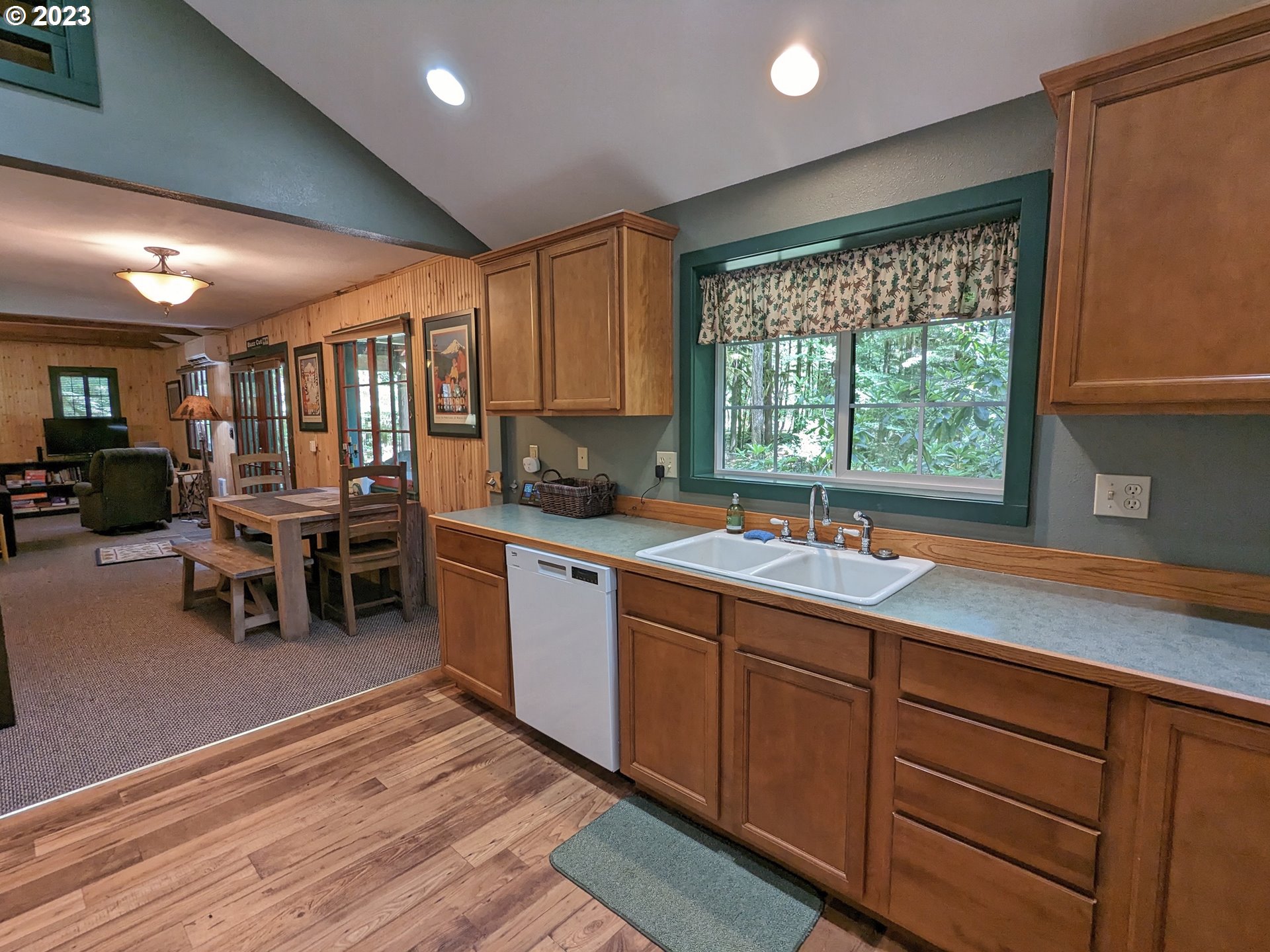 28084 Road 20 D Rhododendron, OR 97049 - Photo 16 of 32 a kitchen with stainless steel appliances granite countertop sink window dining table and chairs