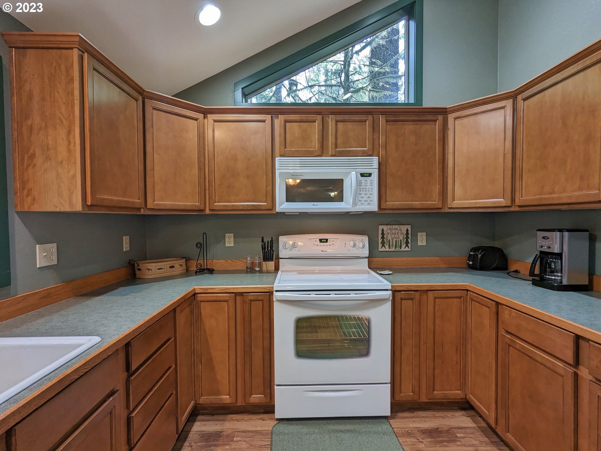 28084 Road 20 D Rhododendron, OR 97049 - Photo 17 of 32 a kitchen with stainless steel appliances granite countertop a stove a sink dishwasher and cabinets with wooden floor