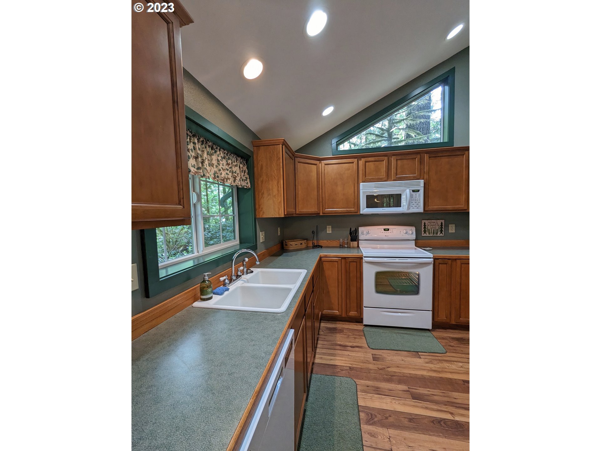28084 Road 20 D Rhododendron, OR 97049 - Photo 18 of 32 a kitchen with stainless steel appliances a stove top oven