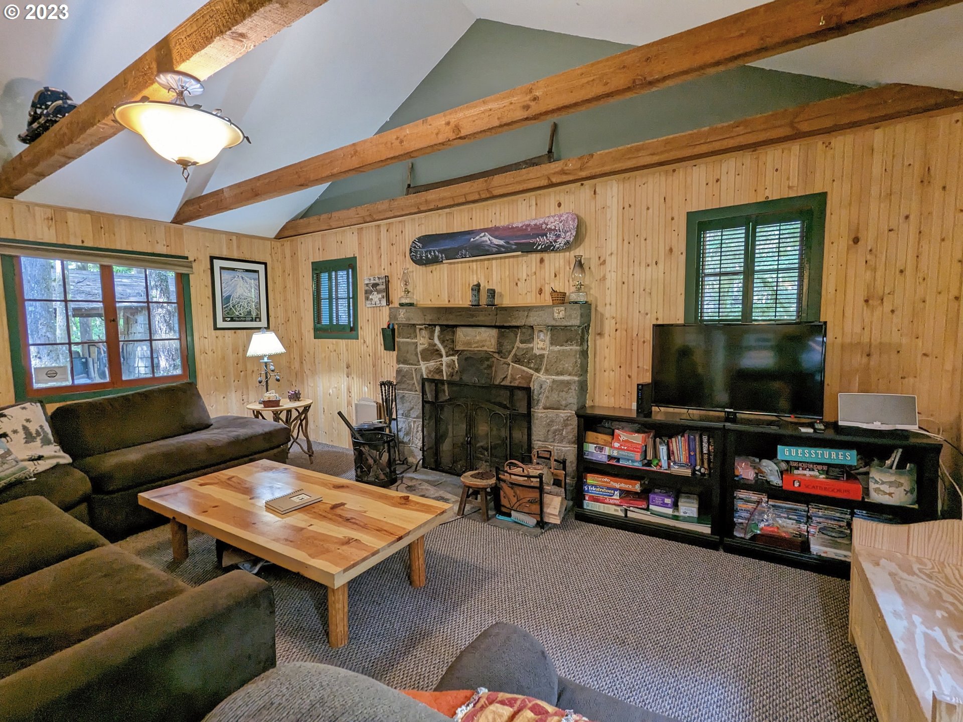 28084 Road 20 D Rhododendron, OR 97049 - Photo 6 of 32 a living room with furniture a flat screen tv and a fireplace