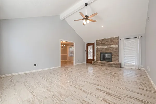 wooden floor in an empty room with a fireplace