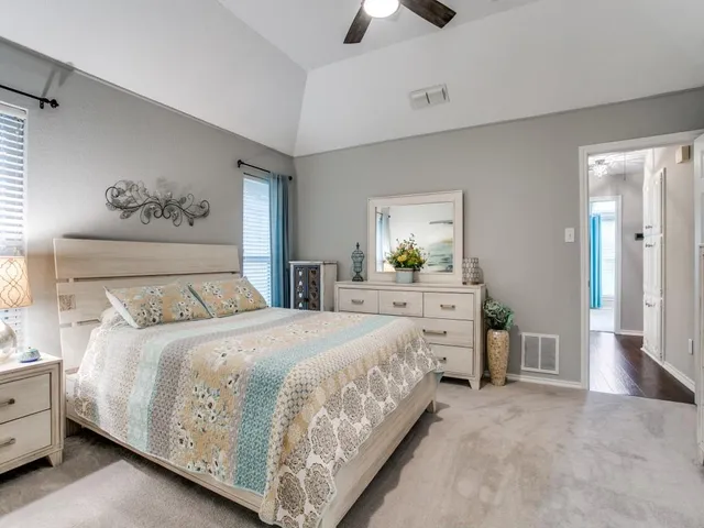 a bedroom with a large bed and a chandelier