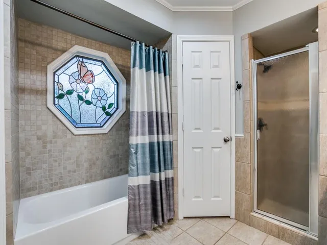 a bathroom with a bathtub and a shower