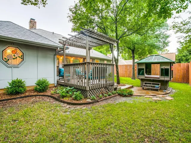 a view of a chair and table in backyard of the house