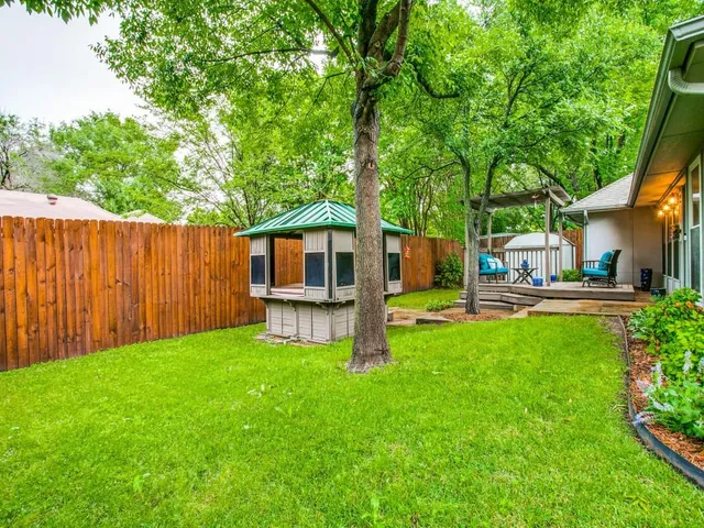 a front view of a house with yard patio and green space