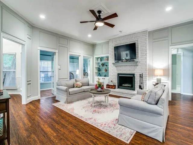 a living room with furniture a flat screen tv and a fireplace