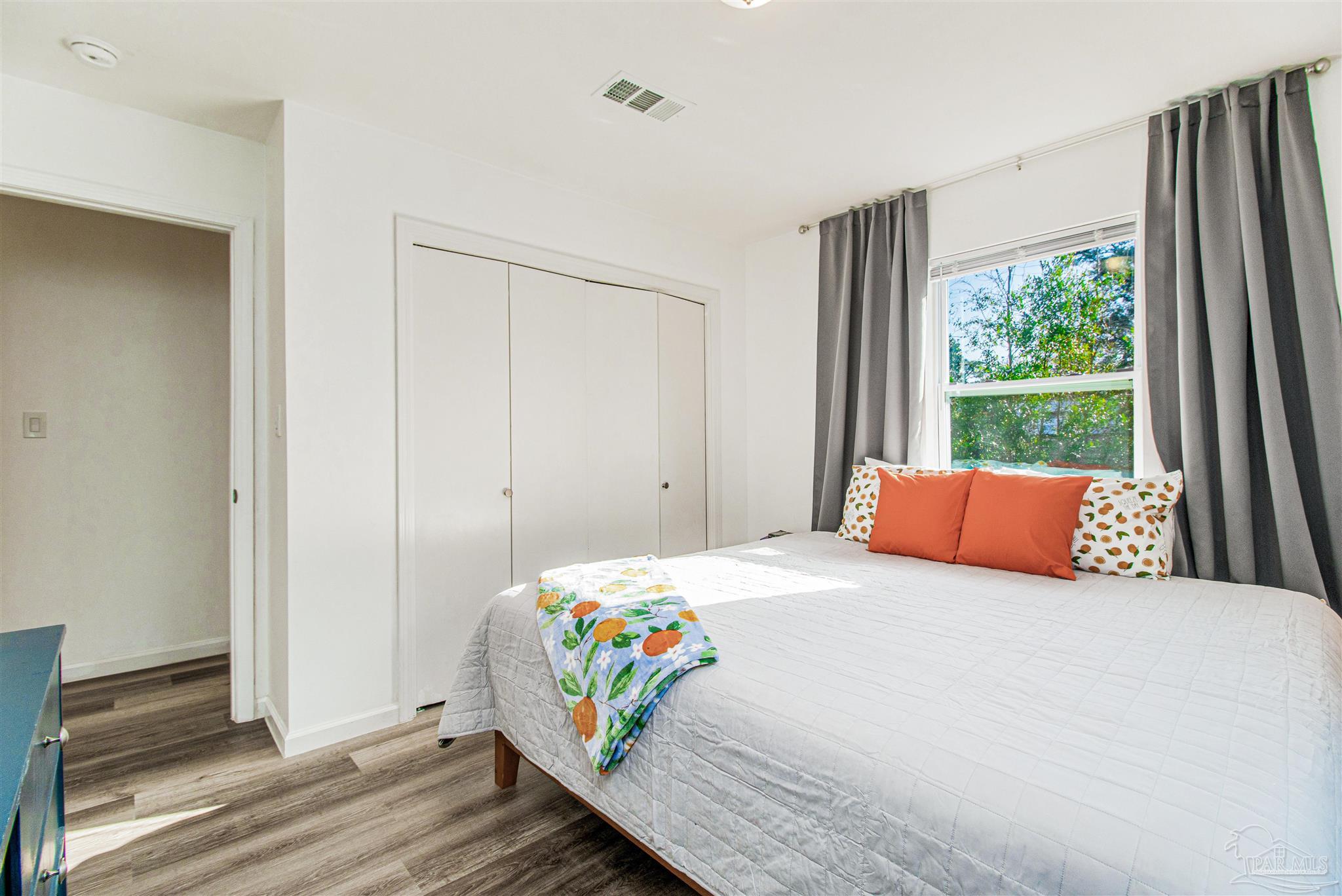 100 Mango Street Pensacola, FL 32503 - Photo 13 of 47 a bedroom with a bed and wooden floor