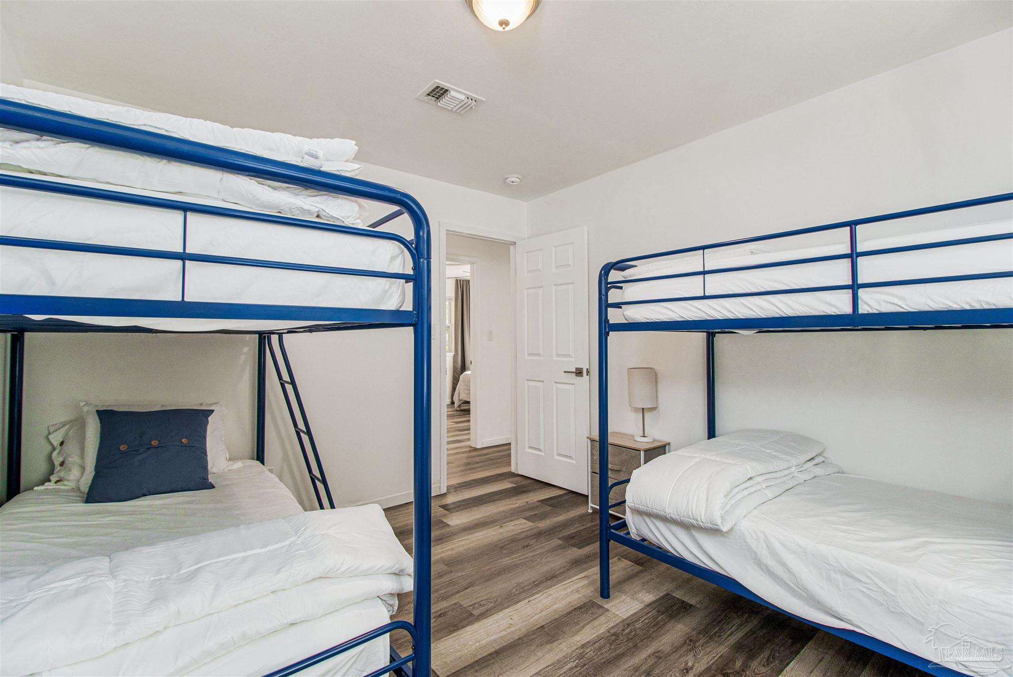 100 Mango Street Pensacola, FL 32503 - Photo 18 of 47 a bedroom with a bed and a mirror