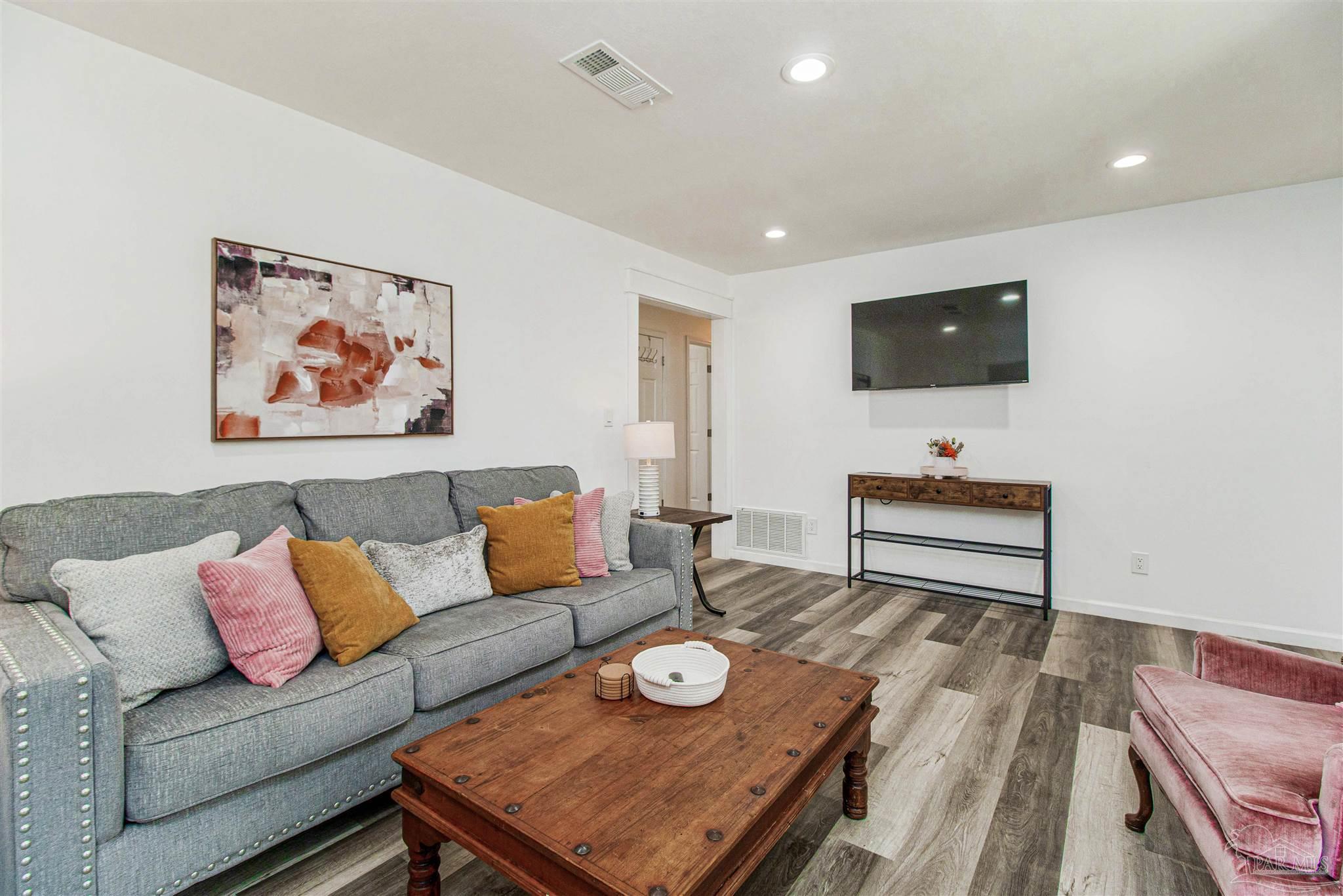 100 Mango Street Pensacola, FL 32503 - Photo 2 of 47 a living room with furniture and a flat screen tv