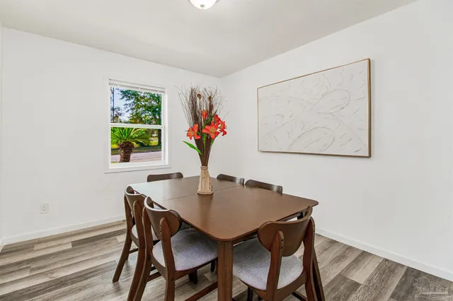 a view of a dining room with furniture and a potted plant