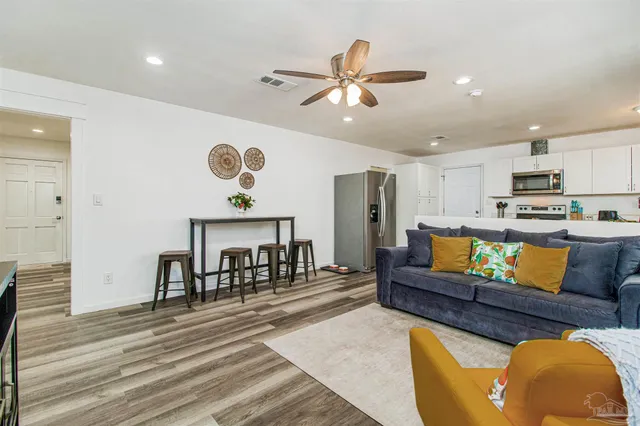 a living room with furniture and kitchen view