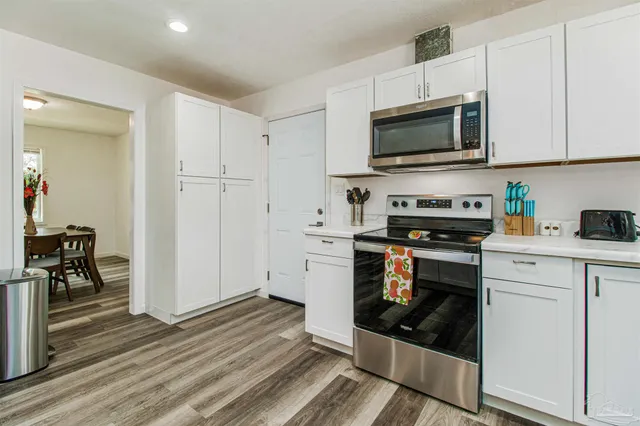 a kitchen with stainless steel appliances a stove a microwave and cabinets