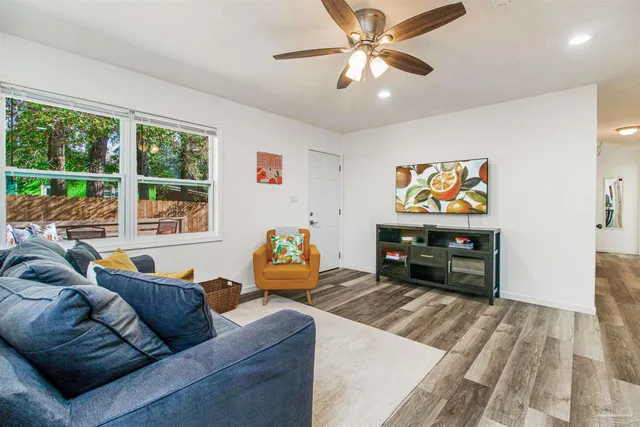 a living room with furniture and a flat screen tv