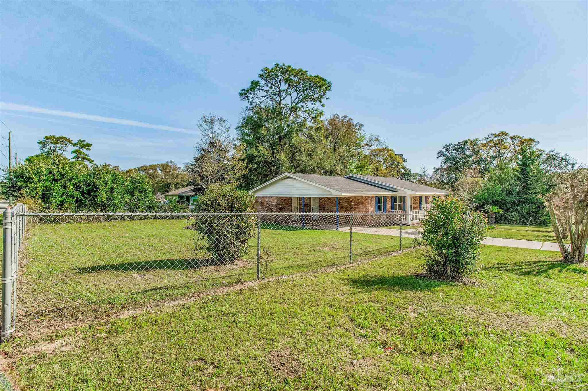 100 Mango Street Pensacola, FL 32503 - Photo 43 of 47 a view of a house with a yard and a large tree