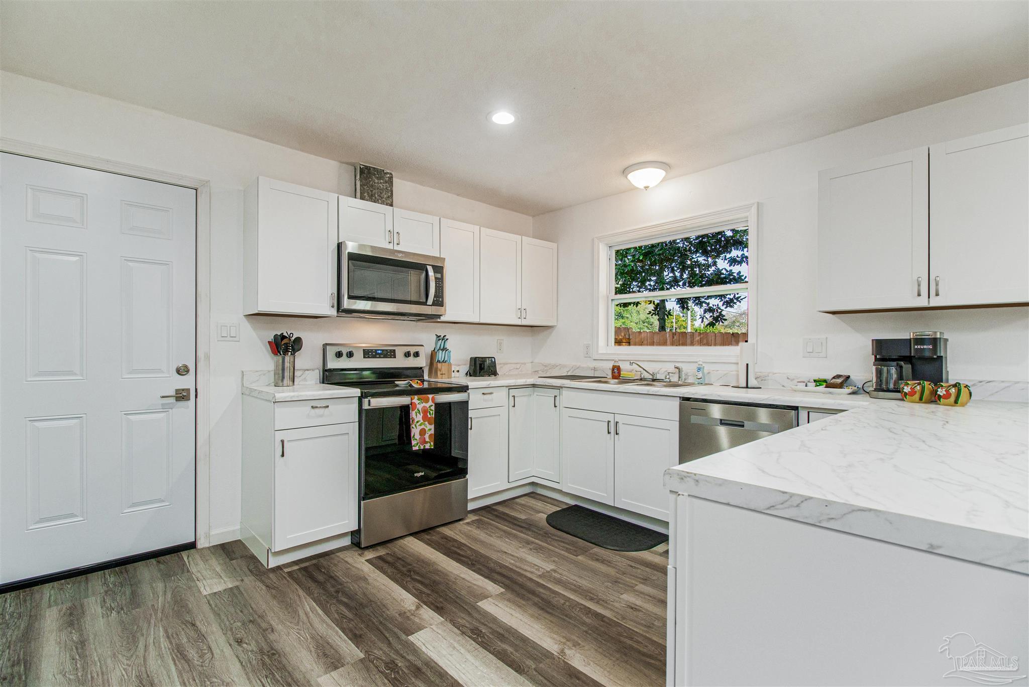 100 Mango Street Pensacola, FL 32503 - Photo 5 of 47 a kitchen with a refrigerator stove and microwave