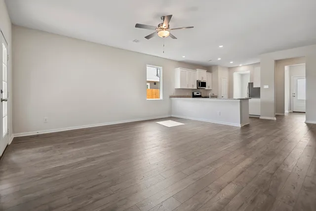 a view of a kitchen with stove and wooden floor