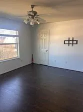 an empty room with a empty space and windows