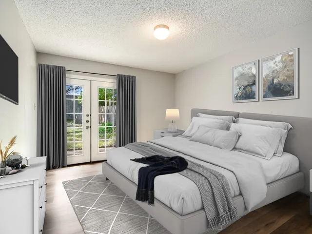 a bedroom with a large bed and a large window