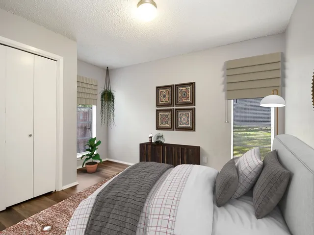 a bedroom with a bed and wooden floor