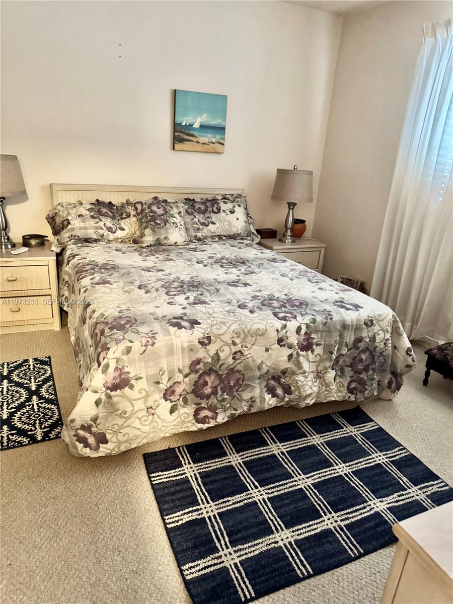 3500 Harrison Street, Unit 7 Hollywood, FL 33021 - Photo 13 of 66 a bed sitting in a bedroom next to a window