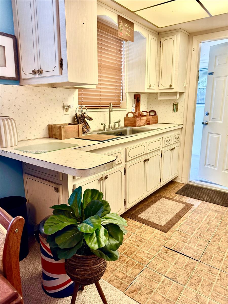 3500 Harrison Street, Unit 7 Hollywood, FL 33021 - Photo 20 of 66 a kitchen with stainless steel appliances a sink a counter top space cabinets and a potted plant