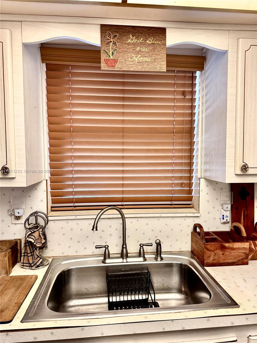 3500 Harrison Street, Unit 7 Hollywood, FL 33021 - Photo 22 of 66 a kitchen with a sink cabinets and window