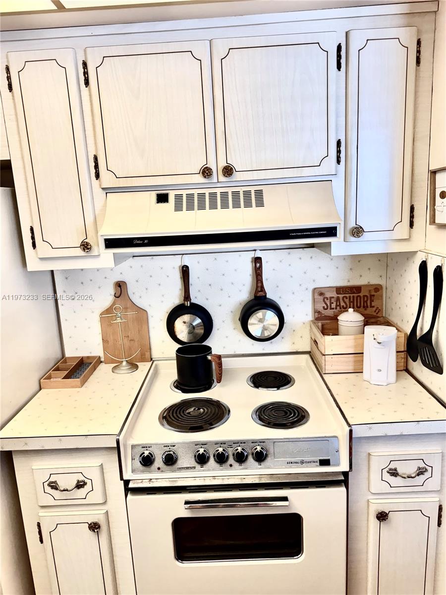 3500 Harrison Street, Unit 7 Hollywood, FL 33021 - Photo 25 of 66 a white stove top oven sitting inside of a kitchen