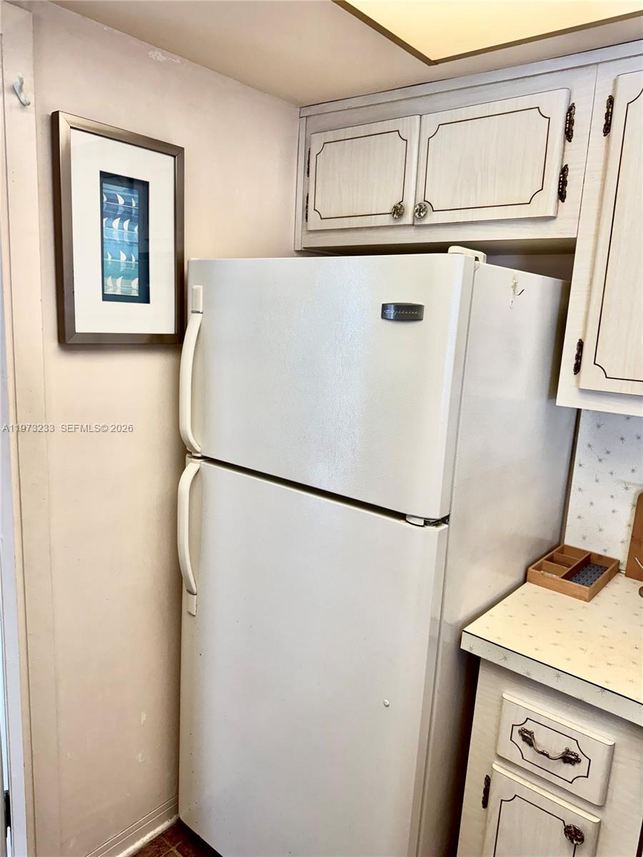 3500 Harrison Street, Unit 7 Hollywood, FL 33021 - Photo 26 of 66 a white refrigerator freezer and a stove sitting inside of a kitchen