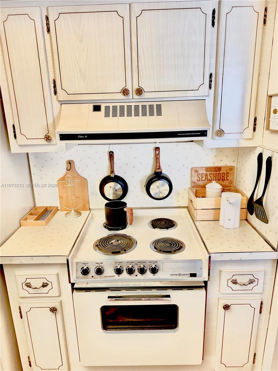 3500 Harrison Street, Unit 7 Hollywood, FL 33021 - Photo 27 of 66 a white stove top oven sitting inside of a kitchen