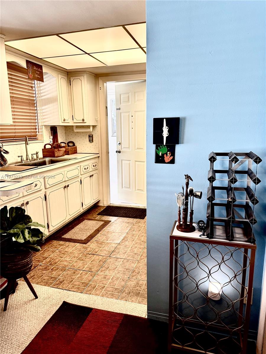 3500 Harrison Street, Unit 7 Hollywood, FL 33021 - Photo 29 of 66 a kitchen with stainless steel appliances kitchen island granite countertop a stove and white cabinets