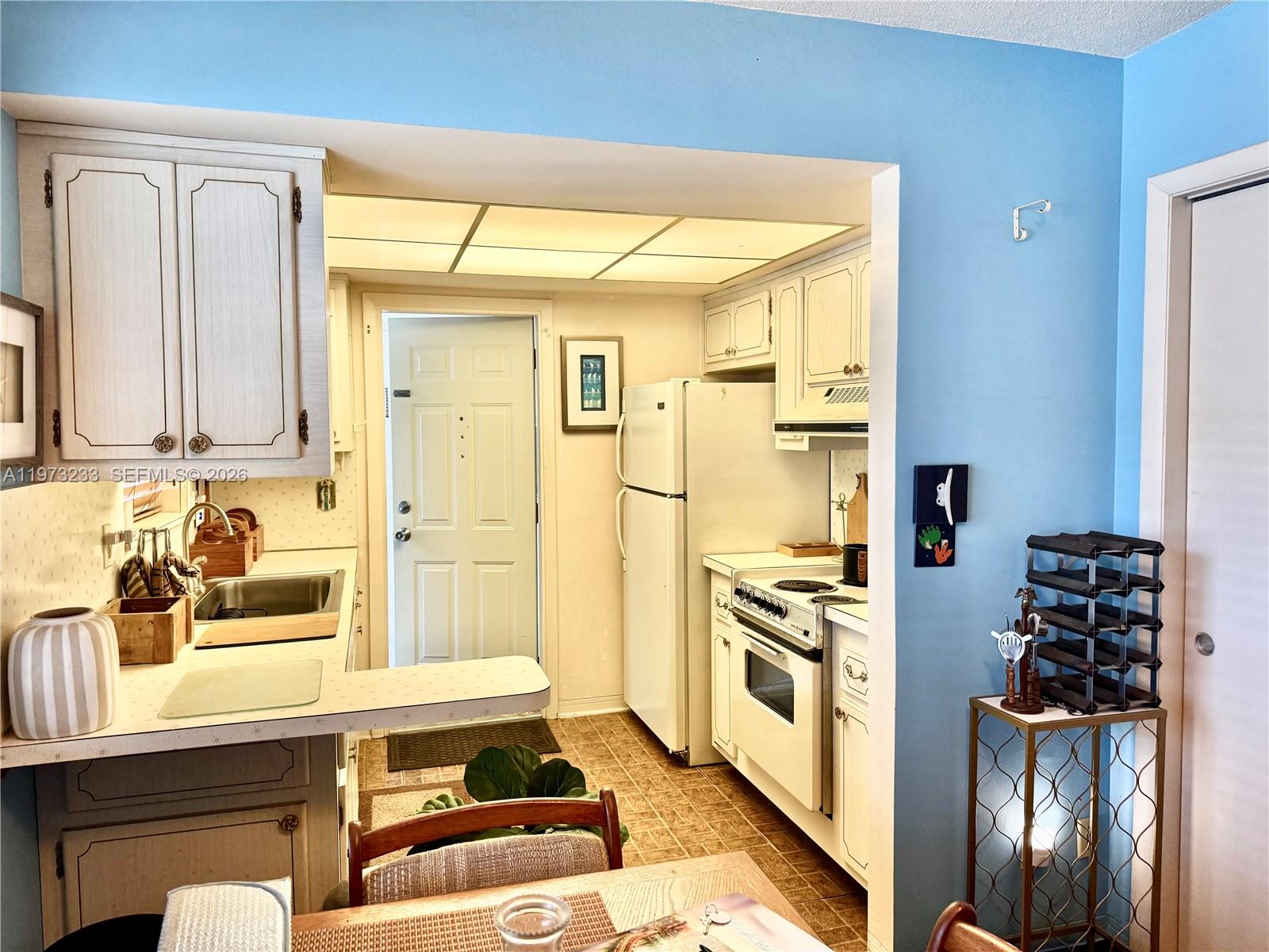 3500 Harrison Street, Unit 7 Hollywood, FL 33021 - Photo 3 of 66 a kitchen with stainless steel appliances a stove and a refrigerator