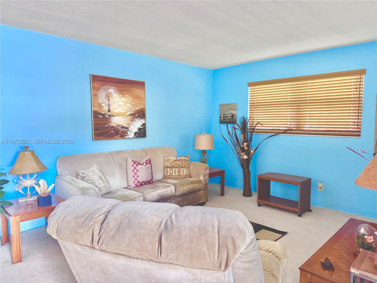 3500 Harrison Street, Unit 7 Hollywood, FL 33021 - Photo 35 of 66 a living room with furniture and a wall painting